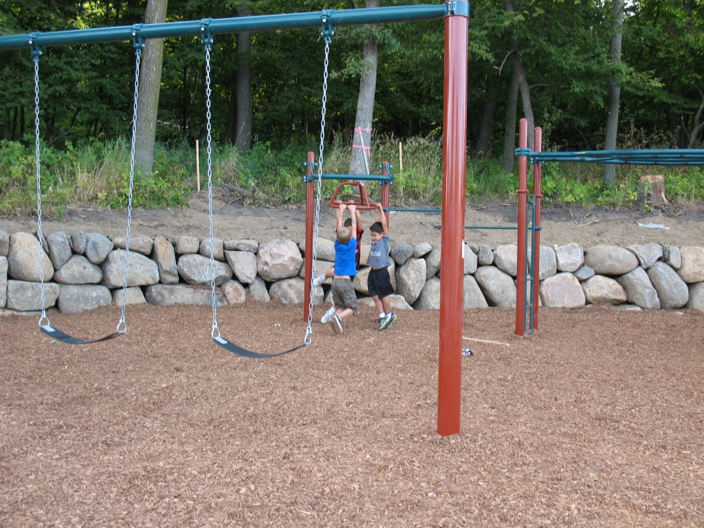 new home builders in Plymouth Minnesota, Playground of new home development in Plymouth Minnesota, luxury homes for sale in private community in Plymouth Minnesota, kids playing on swingset of new playground in Plymouth Minnesota, kids on jungle gym of new playground in wayzata school district 