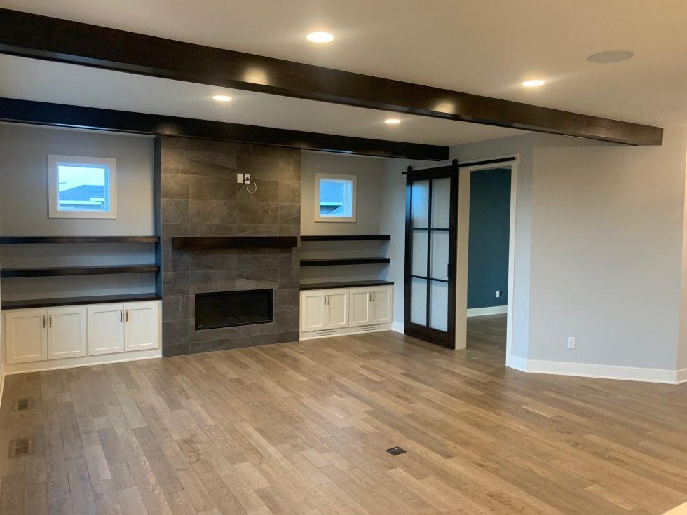 great room with built-ins and a fireplace